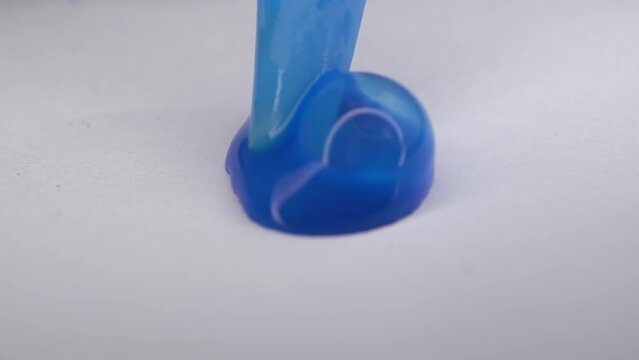 Blue paint is inflated on paper. Bubbles from blue