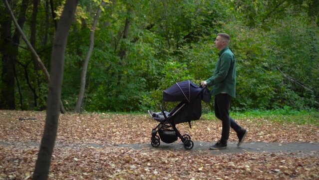 A young father walks through the forest