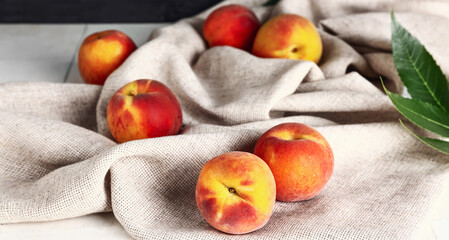 Many sweet peaches on table