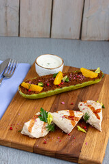 Grilled chicken breast with vegetables. Home made food. Concept for a tasty and healthy meal. Wooden background. Close up.