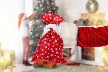 Hand of Santa Claus with bag in room