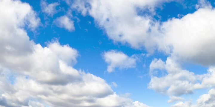 Soft puffy white clouds floating in the azure sky. Clouds quickly transforming in the atmosphere. Low angle view. Timelapse.