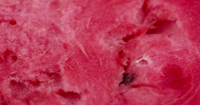 red and juicy pulp of ripe watermelon close-up, red fresh pulp of ripe watermelon with black seeds inside