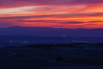 Sunset with colorful sky over mountain landscape near Bardenas Reales Arguedas, Navarra, Spain