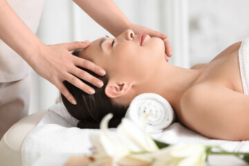 Obraz na płótnie Canvas Young woman having massage in spa salon, closeup