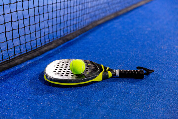 padel racket on a padel court with a ball
