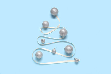 Christmas tree made of balls and ribbon on blue background