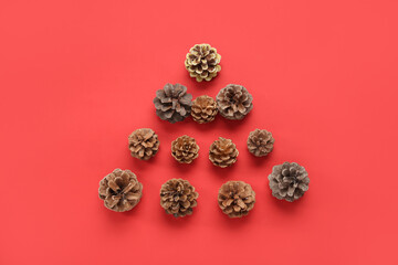 Christmas tree made of cones on red background
