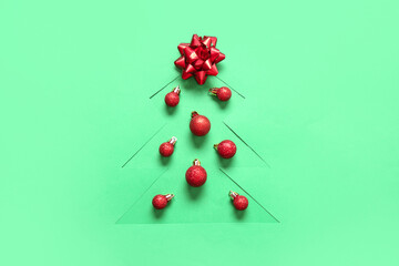 Cut green paper in shape of Christmas tree with balls and bow