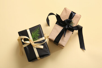Gift boxes with coniferous and Christmas tree branches on yellow background