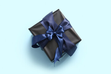 Black Christmas gift box on blue background