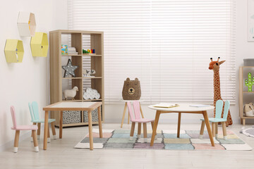 Child`s playroom with different toys and modern furniture. Stylish kindergarten interior - obrazy, fototapety, plakaty