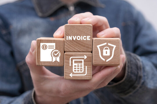 Man holding wooden cubes sees word: INVOICE. Online digital E-invoice and statements software. Payment and billing invoice. Order concept. Tax and paper bank document icon.