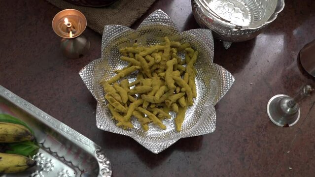 Turmeric sticks on a silver plate during an india tradition