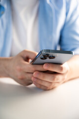 Closeup of unrecognizable man holding smartphone in hands for surfing internet, watch videos,play games,do online shopiping etc