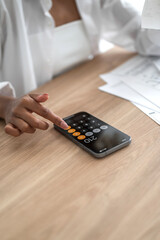 Closeup Woman hand on phone calculator.finances ,expenses,debt ect