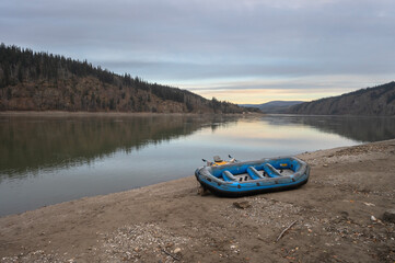 Morning view of an inflatable raft on the shore of the Yukon River at Dawson City, Yukon, Canada