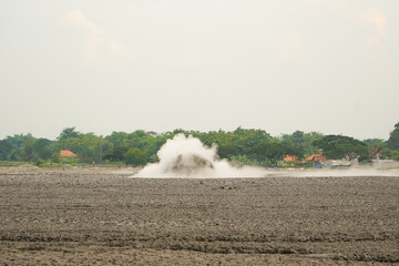 A mud volcano or mud dome is a landform created by the eruption of mud or slurries, water and...