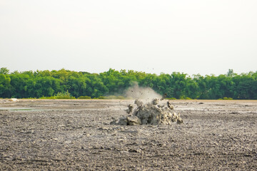 A mud volcano or mud dome is a landform created by the eruption of mud or slurries, water and gases. Bledug Kuwu is a mud volcano located in Kuwu Village, Purwodadi, Grobogan, Central java, Indonesia.