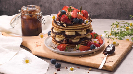 Pancakes with fruits and chocolate sauce