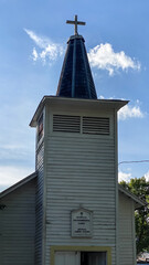 Church Steeple and Cross against Blue Sky