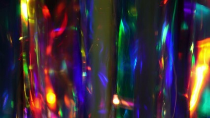 A diamond sparkling with different rainbow neon colors on a dark background. Prism Light Flares...