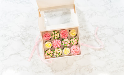 Fototapeta na wymiar Delicious Gourmet Cupcakes Topped with Buttercream Frosting Flowers