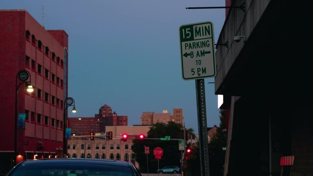 15 minutes parking 8AM to 5PM road sign timelapse in rockford Illinois, USA. Static shot sunset. Day to night.