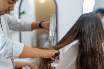 Cropped photo of a hairdresser and customer in a salon