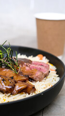Tender New York Sliced Beef Served with Buttery Rice and Fresh Vegetables
