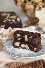 Decadent Black and Brown Brownies with a Generous Almond Topping - Irresistible Dessert Temptation