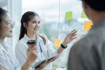 Business people meeting at office and use post it notes to share idea. Brainstorming concept....