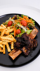 Succulent Grilled Ribs with French Fries and Vegetables