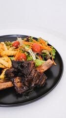 Succulent Grilled Ribs with French Fries and Vegetables