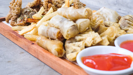 Nusantara Platter: A Flavorful Feast of French Fries, Crispy Fried Chicken Skin, Fried Mushroom, and Bakso Tahu Special with Delicious Condiment Sauces
