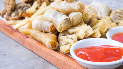 Nusantara Platter: A Flavorful Feast of French Fries, Crispy Fried Chicken Skin, Fried Mushroom, and Bakso Tahu Special with Delicious Condiment Sauces