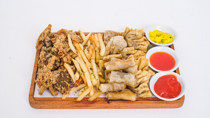 Nusantara Platter: A Flavorful Feast of French Fries, Crispy Fried Chicken Skin, Fried Mushroom, and Bakso Tahu Special with Delicious Condiment Sauces