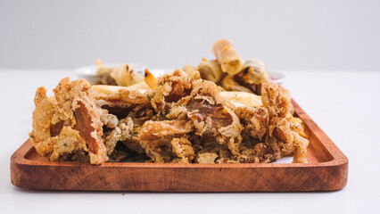Nusantara Platter: A Flavorful Feast of French Fries, Crispy Fried Chicken Skin, Fried Mushroom, and Bakso Tahu Special with Delicious Condiment Sauces