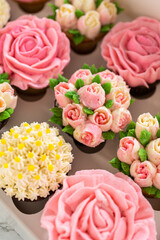 Obraz na płótnie Canvas Delicious Gourmet Cupcakes Topped with Buttercream Frosting Flowers
