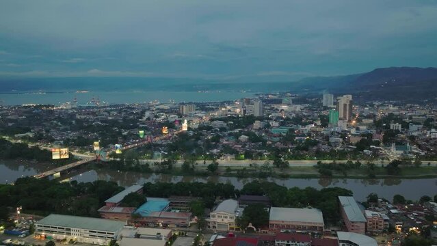 Cagayan de Oro city at dusk time with buildings near the river. Mindanao, Philippines.