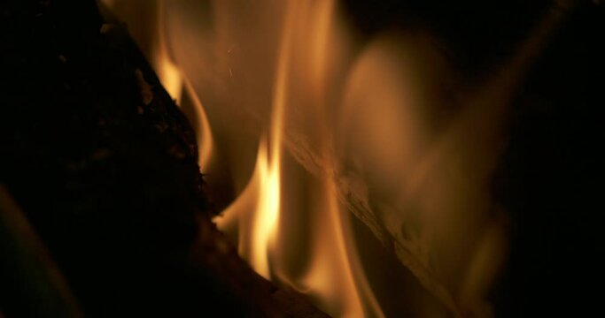 Closeup of fire. Filmed in superslow motion 800fps. The footage was taken of a bonfire. Shows particles and flames in 4k.