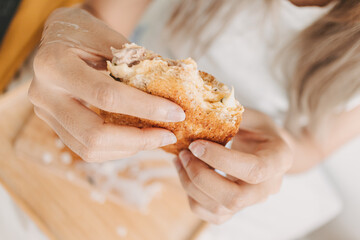 Close up of woman hands holding homemade sandwich. breakfast in the morning.