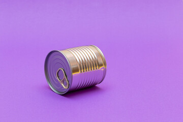 Unopened Tin Can with Blank Edge on Violet Background. Canned Food. Aluminum Can for Safe and Long Term Storage of Food. Steel Sealed Food Storage Container