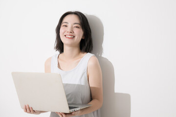 Obraz premium パソコンを持つ笑顔の女性