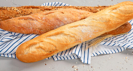 Fresh baguette bread on light background. Traditional French food