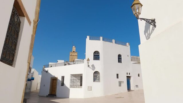 Quaint white houses in Kasbah of the Udayas, Morocco. Tilt down daylight shot 