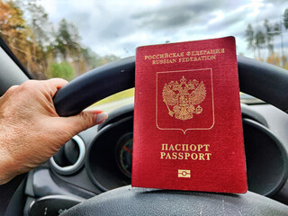 Russian passport in hand of driver woman. Russian cars banned for entering in Europe. Russian...