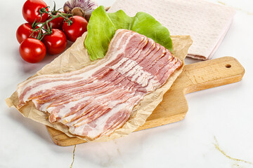 Sliced pork bacon oved board