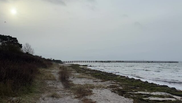 boardwalk on empty beach near calm ocean