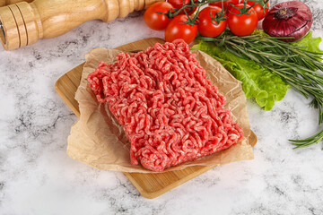 Raw minced beef meat on cutting board